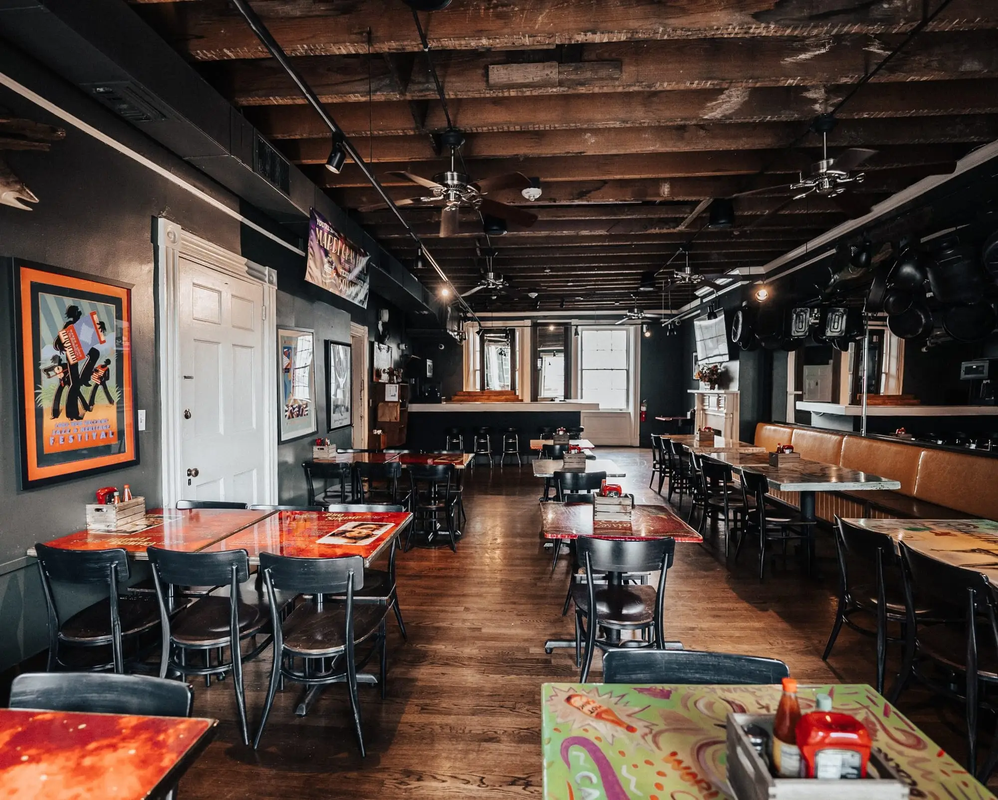 Mardi Gras Room tables with painted tops and carnival art on the walls
