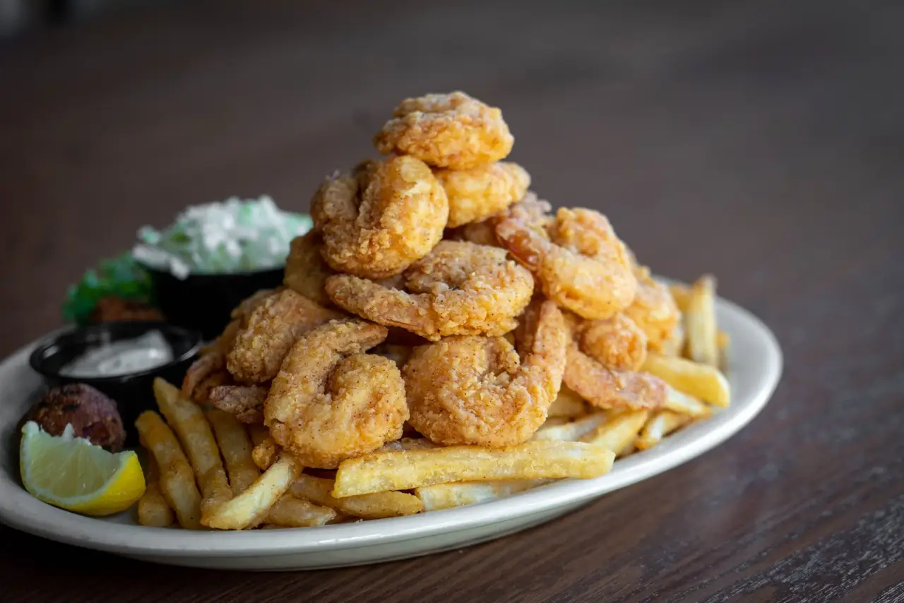 Fried shrimp platter with french fries, coleslaw, lemon and cocktail sauce
